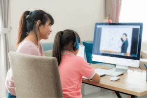 mom guiding her child in virtual learning