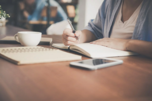 woman writing on a notebook