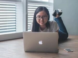 female student looking at her notes in her laptop