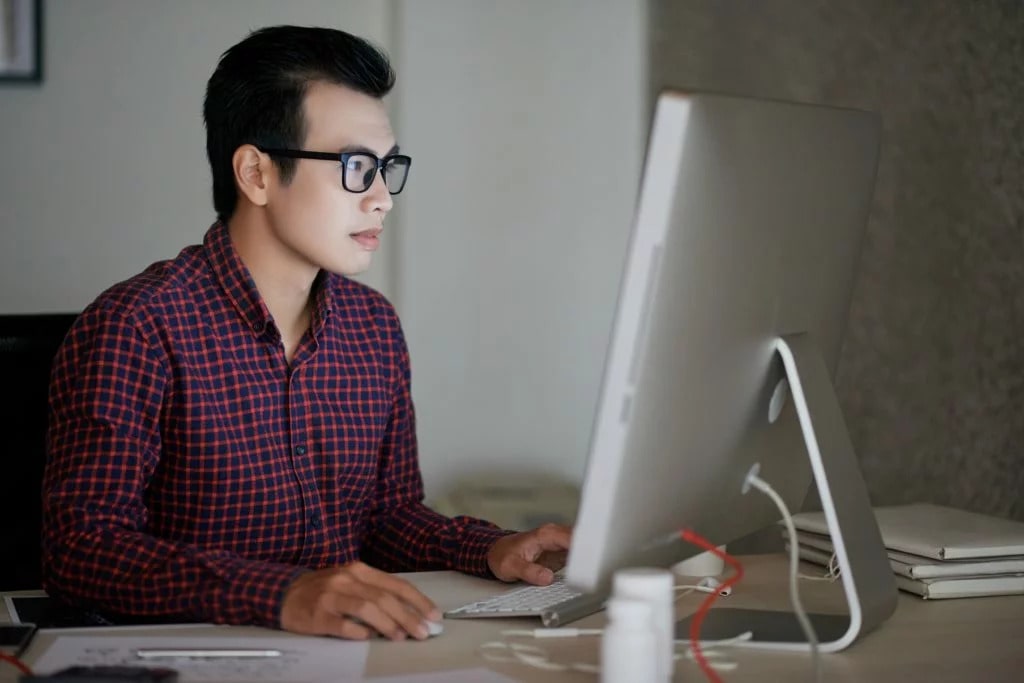 a male student using a computer