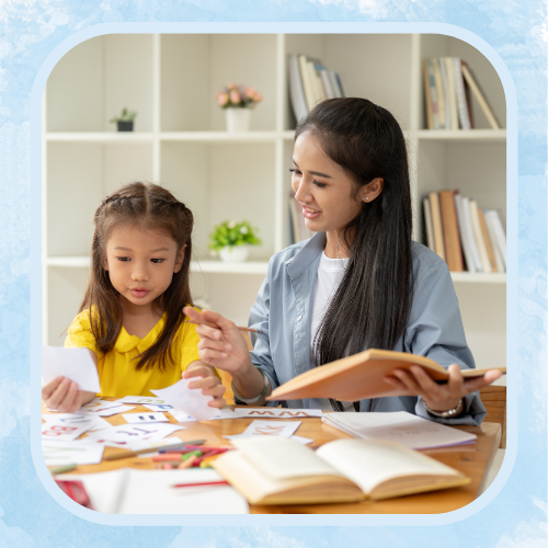 girl studying with a female teacher holding a book